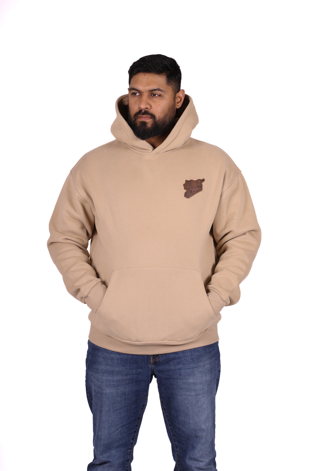 Man wearing a beige hoodie with a logo on a white background