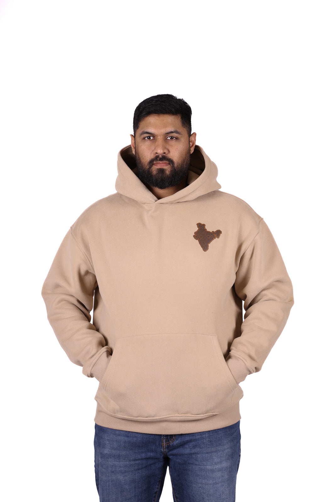 Man wearing a beige hoodie with a logo on a white background