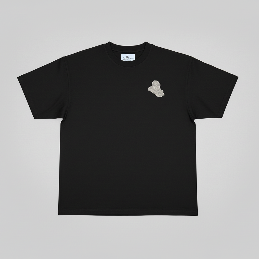 Black t-shirt with a small graphic on the chest against a gray background