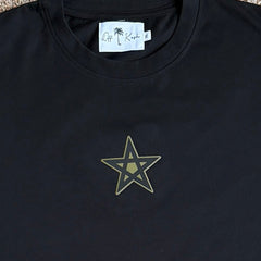 Black t-shirt with a star design and brand label on a plain background