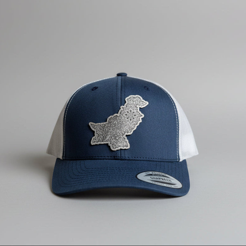 Navy blue and white cap with a decorative patch on a gray background